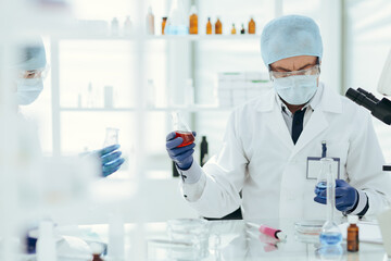 Fototapeta premium scientists colleagues checking the liquid in laboratory flasks.