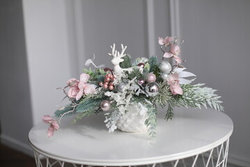 Cristmass decoration  with deer and pine and candles  on table and in hands