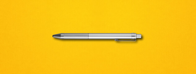 Metal pen isolated on yellow background