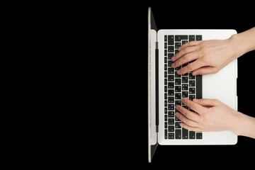 Fototapeta na wymiar Top view of businessman hands busy using laptop at black office desk.