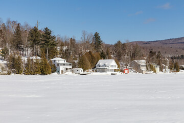 Lake Willoughby covered with ice and snow at winter. Sunny day.