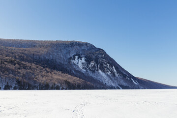 Fototapeta premium Lake Willoughby covered with ice and snow at winter. Sunny day.