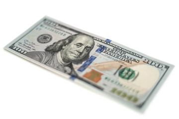 100 Dollars bill and portrait Benjamin Franklin on USA money banknote. Hundred dollar bills on wooden background..