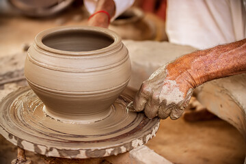 Potter at work makes ceramic dishes. India, Rajasthan.