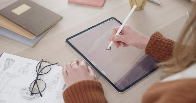 Over shoulder view of female artist drawing illustration on tablet while sitting at workplace. Graphic illustrator using digital pad and stylus while creating picture. Concept of art