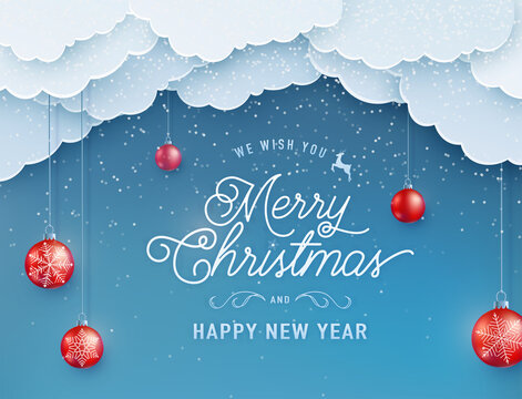 Merry christmas happy new year vector background. Winter holiday banner with red decoration ball on the string, sky clouds on the top, falling snow texture effect and greeting text in papercut style