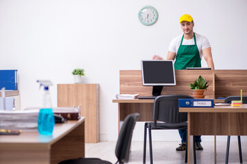 Young male contractor cleaning the office
