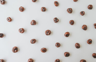 Top view of chestnuts on white wooden background.