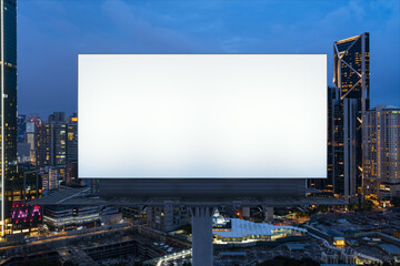 Blank white road billboard with KL cityscape background at night time. Street advertising poster, mock up, 3D rendering. Front view. The concept of marketing communication to promote or sell idea. © VideoFlow