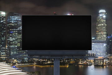 Blank black road billboard with Singapore cityscape background at night time. Street advertising poster, mock up, 3D rendering. Front view. The concept of marketing communication to sell idea.