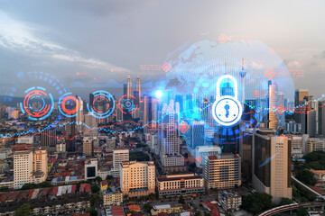 Hologram of Padlock on sunset panoramic cityscape of Kuala Lumpur, Malaysia, Asia. The concept of cyber security intelligence in KL. Multi exposure.