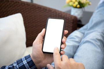 male hands holding phone with isolated screen on background room