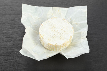 Cheese  Camembert on a black board for serving food.