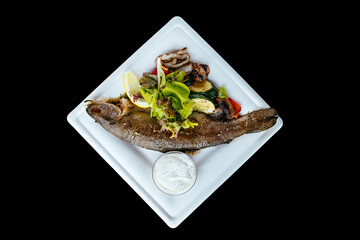 Whole fried trout with herbs and sauce