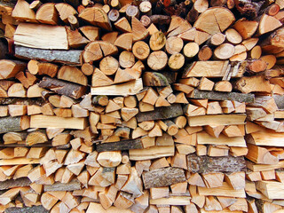 a stack of firewood in front of a house
