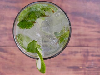 ice cubes and mint leaves in the mojito drink glass from above