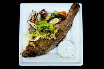 Whole fried trout with herbs and sauce