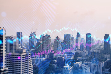 Forex and stock market chart hologram over panorama city view of Bangkok, the financial center in Asia. The concept of international trading. Double exposure.