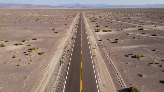 Aerial shot of a remote desert road with no cars in Nevada