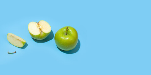 Ripe parts green apple Isolated on a blue background. Healthy eating and dieting concept. Copy space. Free space for your text