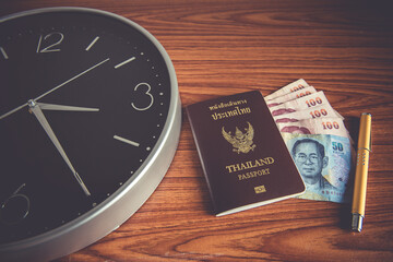 Thailand passport and money with time management concept
