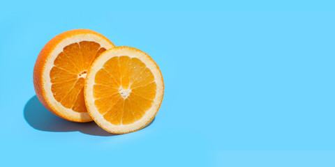 Ripe juicy delicious orange on blue background. Healthy eating and dieting concept. Copy space. Free space for your text