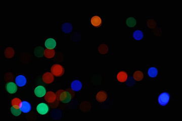 green and blue and orange abstract urban realistic blurred glitter light colorful texture on black.