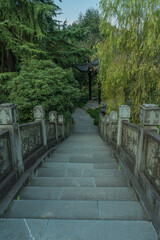 A Chinese stone bridge at the lakeside of West lake in Hangzhou, China, autumn time.