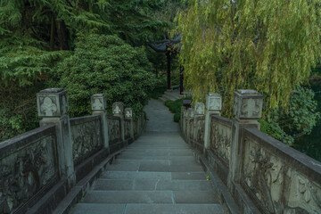 A Chinese stone bridge at the lakeside of West lake in Hangzhou, China, autumn time.