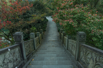 A Chinese stone bridge at the lakeside of West lake in Hangzhou, China, autumn time.