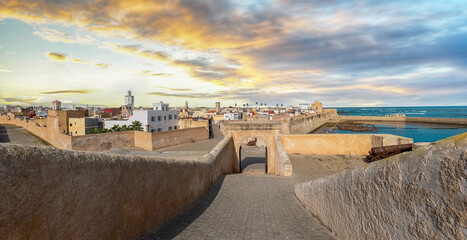 Panoramic view of Mazagan in El Jadida, Morocco at sunset. The City Wall around  the old city. It is a Portuguese Fortified Port City registered as a UNESCO World Heritage Site. Panorama. - obrazy, fototapety, plakaty