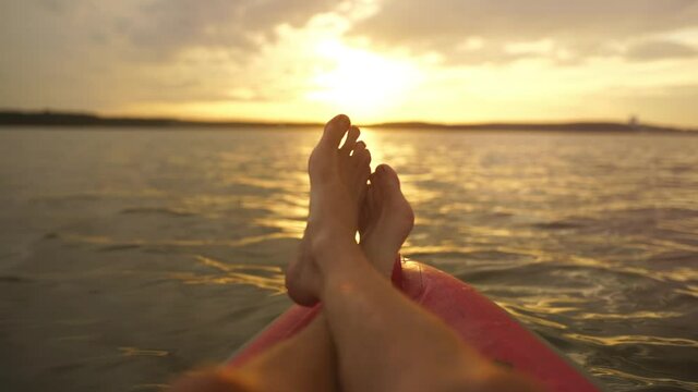 Legs of a relaxed lying person on a boat