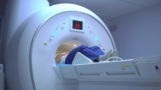 Coronavirus danger, Covid-19 diagnostics, Lung damage. A patient during a computed tomography of the lungs. Human lung scans. 4K