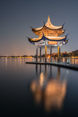 Fototapeta premium Night view of Jixian pavilion, the landmark at the West Lake in Hangzhou, China.