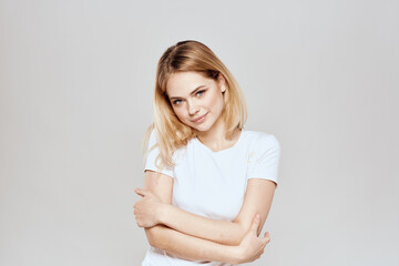 Obraz premium Cute blonde white t-shirt gesture with hands lifestyle light background