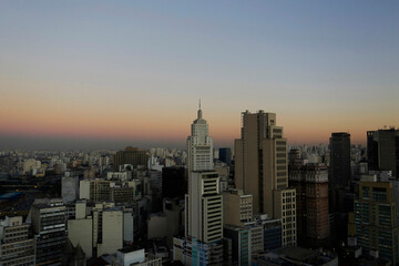 Fototapeta premium A thick layer of pollution is seen in the horizon during sunset in downtown Sao Paulo, Brazil.