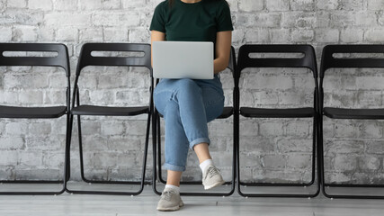 Preparing for interview. Capable confident young lady job seeker using laptop checking cv resume...