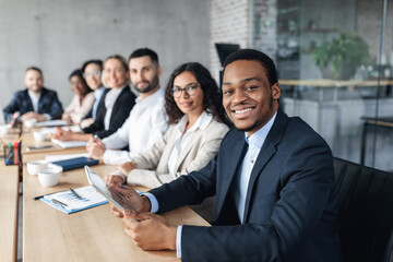 African Businessman On Corporate Meeting With Colleagues Sitting In Office