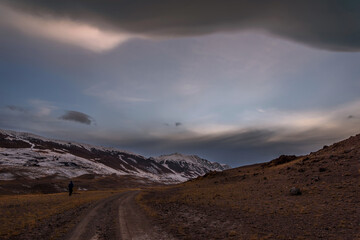 mountains steppe clouds sky road sunset