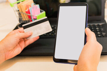 Online payment, woman hands with smart phone and using credit card for online shopping.