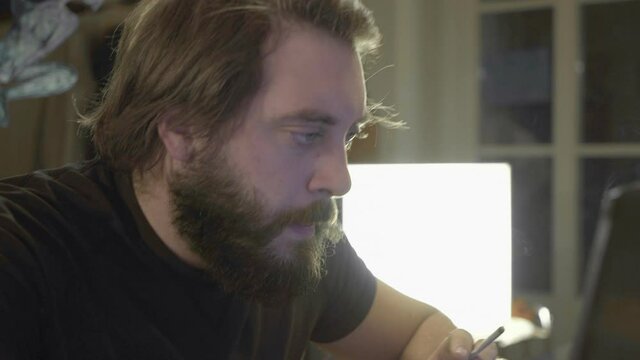 Beardy Man Writing on PC
