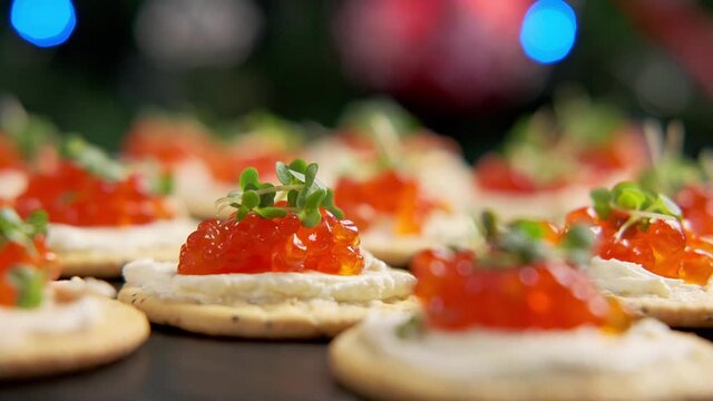 Salmon caviar and soft cheese savory crackers, Christmas party food. rotating video