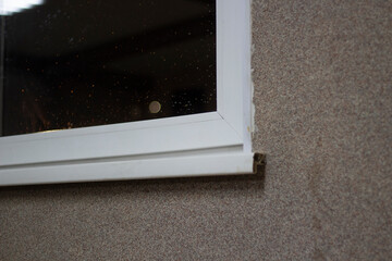 Plastic window in the house. Window sill corner.