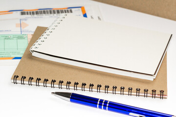 notebooks and a pen on the table for information. A place for text. Business, marketing, financial concept