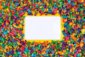 Creative layout made of colorful sawdust around yellow frame with empty space for text