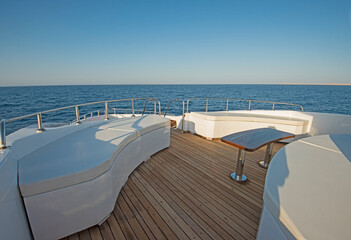 Fototapeta na wymiar Table and chairs on deck of a luxury motor yacht