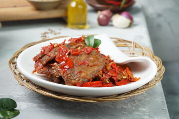 Indonesia traditional food, Dendeng Balado or beef jerky mix with chili and herbs and spices placed...