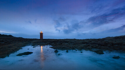 lighthouse on the shore of the sea