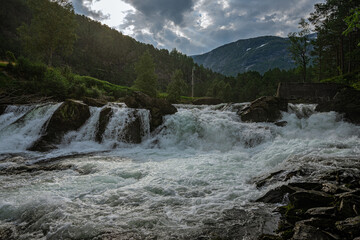 Strong and wide waterfall at the Fossestien