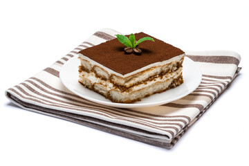 Traditional Italian Tiramisu square dessert portion on ceramic plate isolated on white background with clipping path